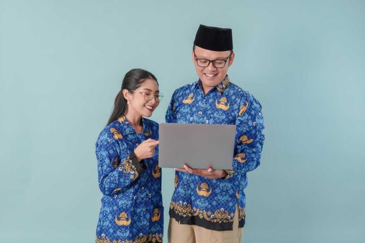 happy-indonesian-government-workers-wearing-blue-batik-uniform-holding-pointing-laptop.jpg
